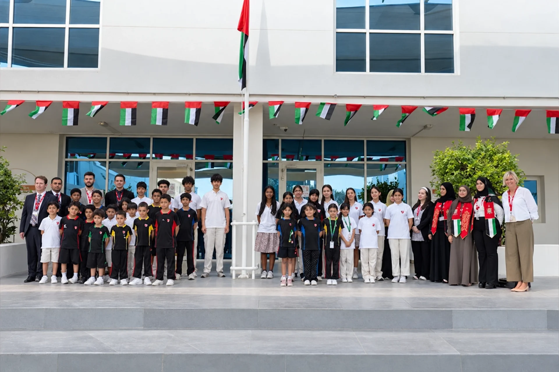 IGCSE vs A Level difference: students and staff gathered at the school entrance